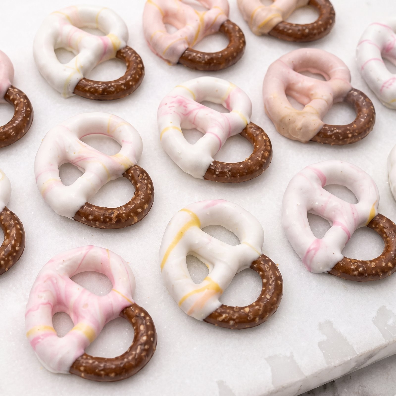 Chocolate-covered pretzels with white chocolate drizzle